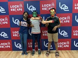 3 kids standing in front of an escape room